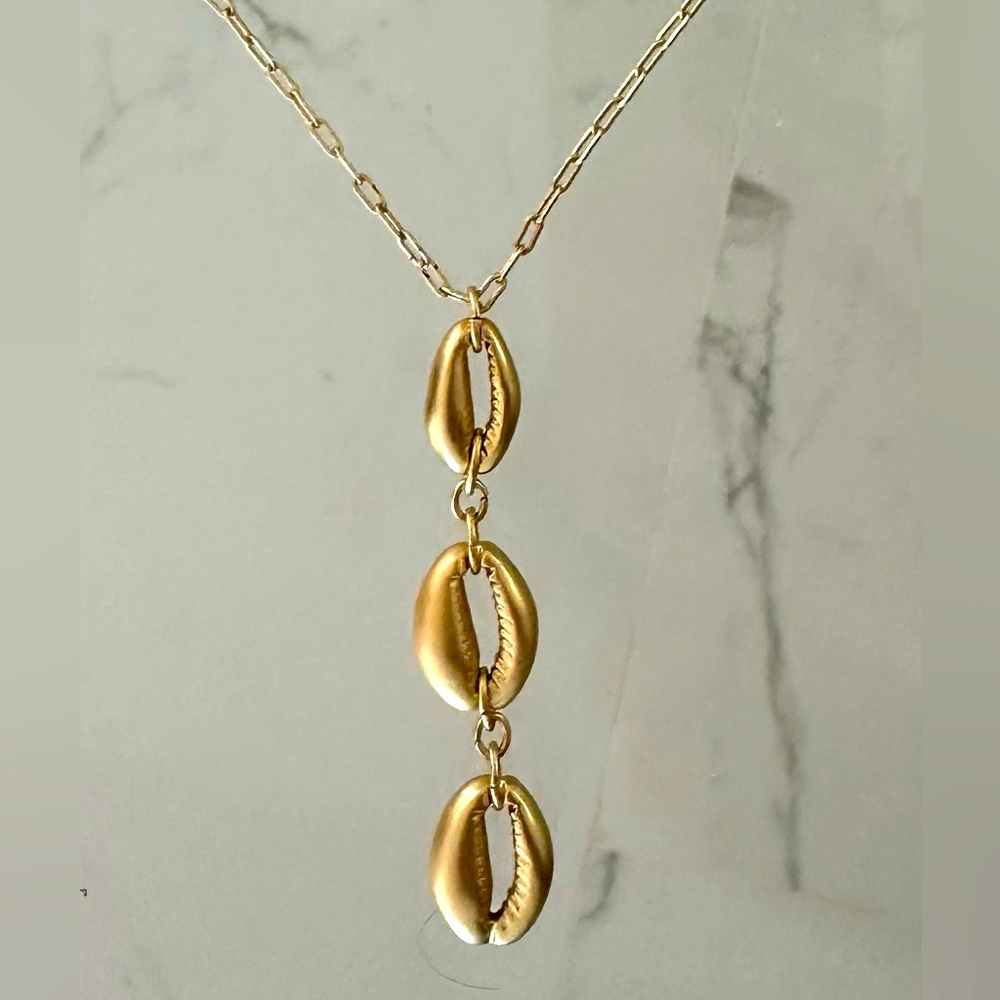 new Gold necklace. 3 shapes hanging down, flattering especially with a V neck